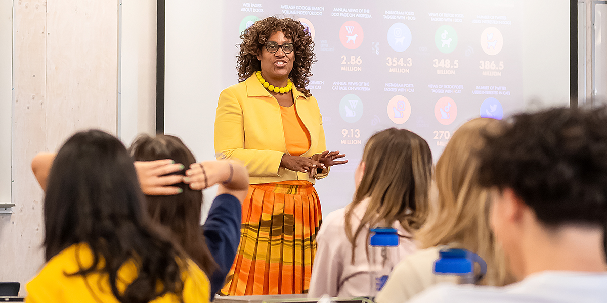 An instructor interacting with students in a classroom