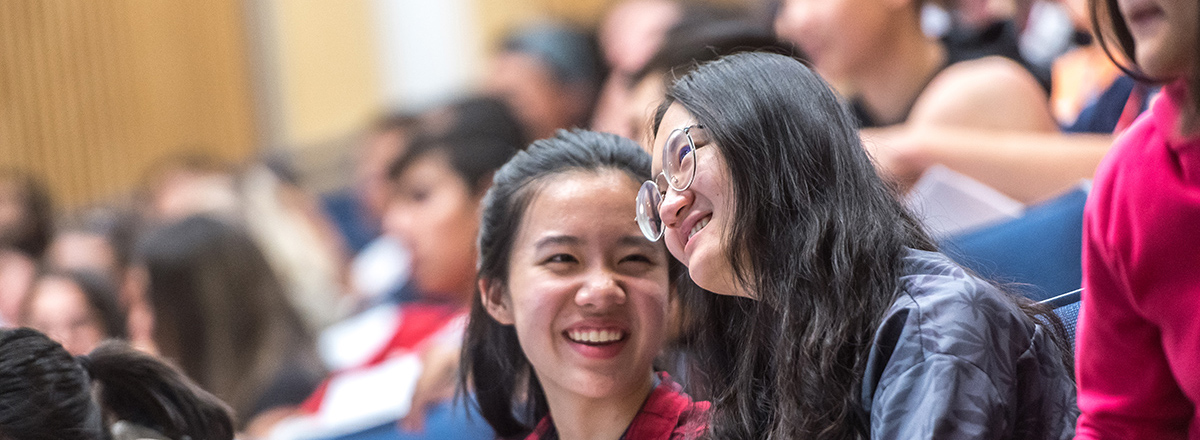 Close-up photograph of two female students in a lecture