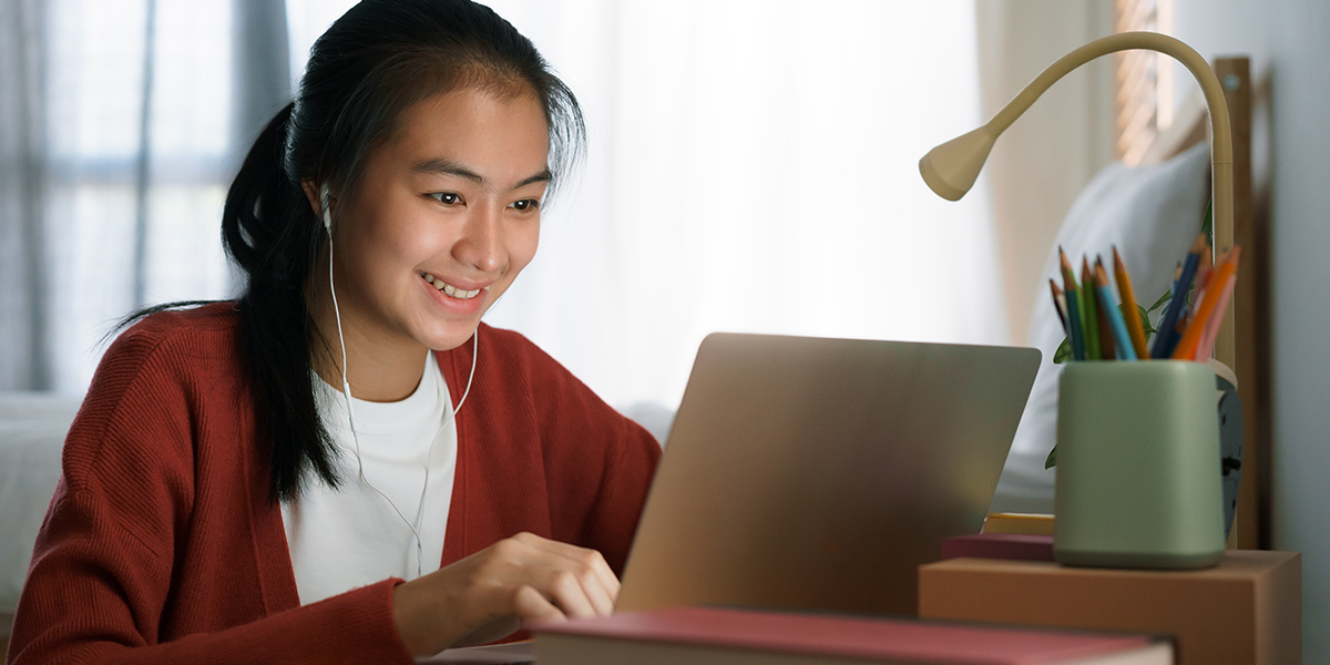 Male student studying on a laptop at home